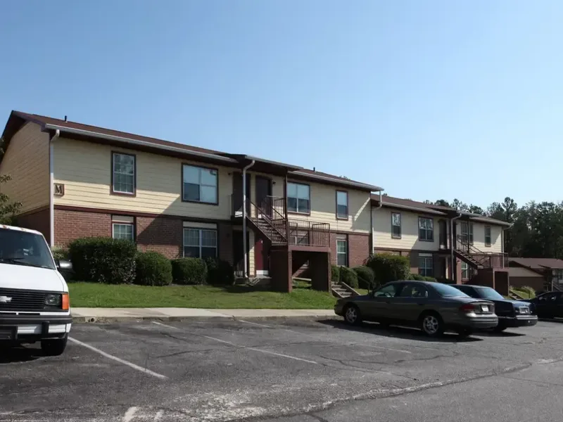 Multi-unit apartment building exterior with parking lot